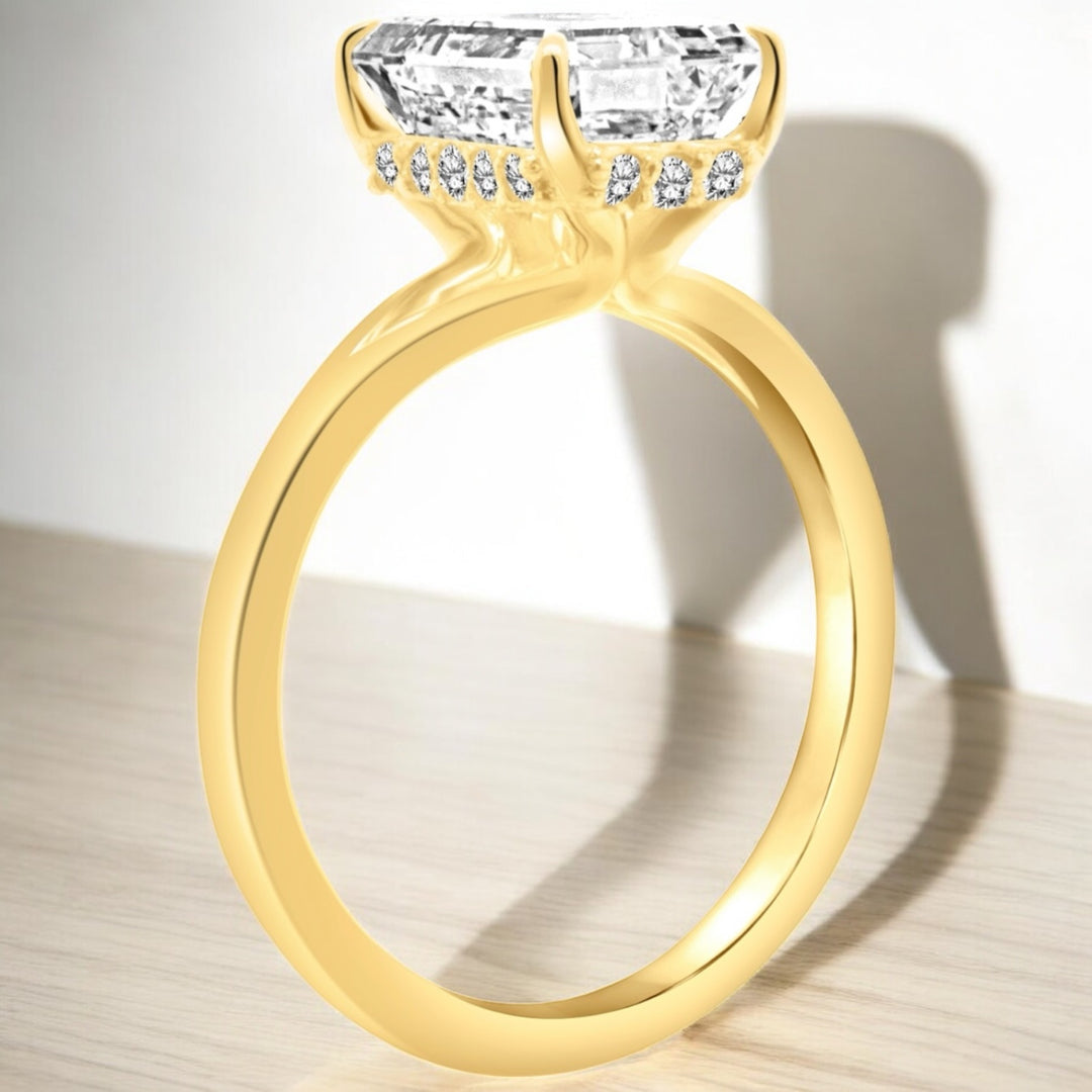 An image showing an alternate view of the finished product of the 14 Karat Emerald Shape Hidden Halo Lab Grown Diamond Engagement Ring