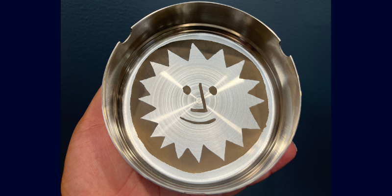 An image of the stainless steel ashtray engraved with a customer's logo