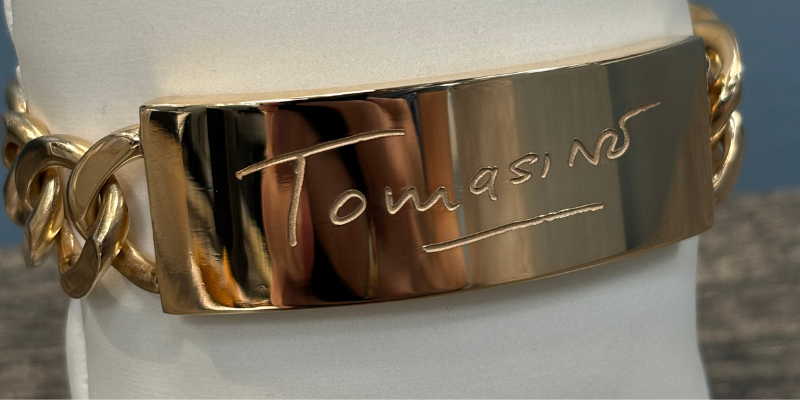 An image showing the bracelet with the signature laser engraved on it