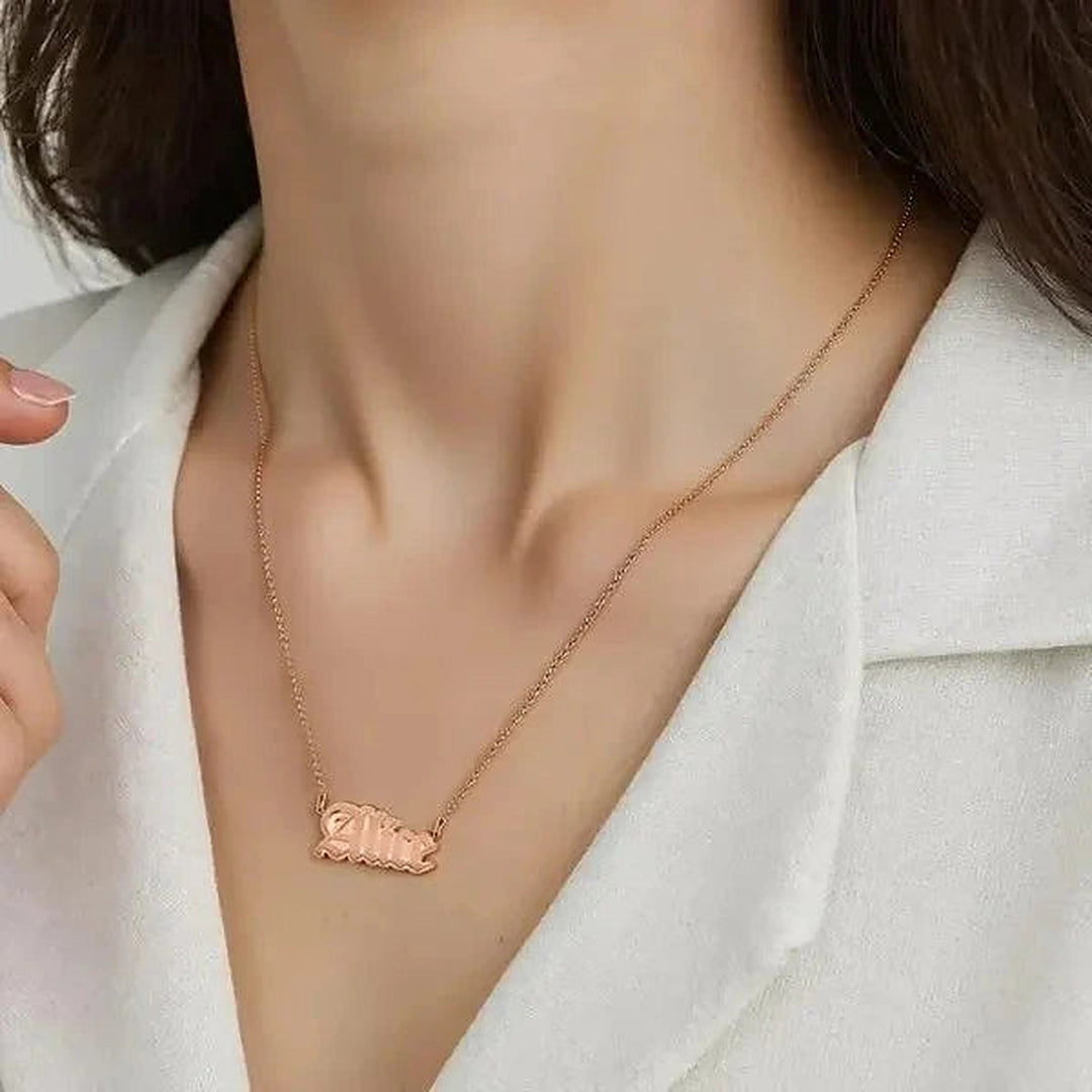 Model wearing the 14 Karat Gothic Style Name Necklace in 14K rose gold personalized with the name Alice | AJ's Jewelry