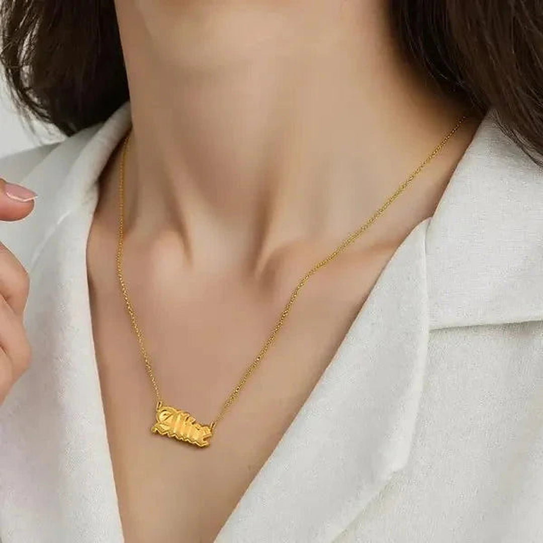 Model wearing the 14 Karat Gothic Style Name Necklace in 14K yellow gold personalized with the name Alice | AJ's Jewelry