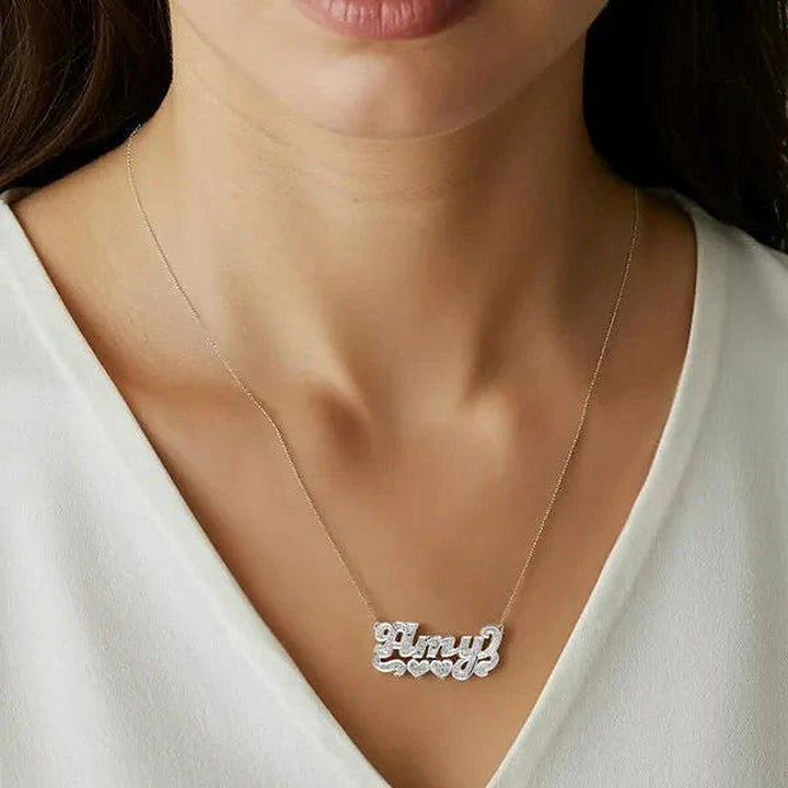 Model wearing the 14 Karat Diamond Cut 3D Name Necklace with Two Hearts in 14K white gold, name Amy | AJ's Jewelry