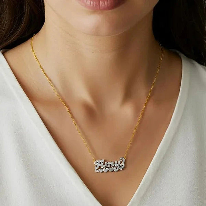 Model wearing the 14 Karat Diamond Cut 3D Name Necklace with Two Hearts in 14K yellow gold, name Amy | AJ's Jewelry