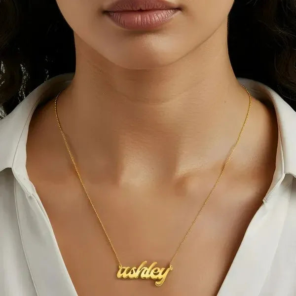 Model wearing a 14 Karat bold letter gold "ashley" name necklace.