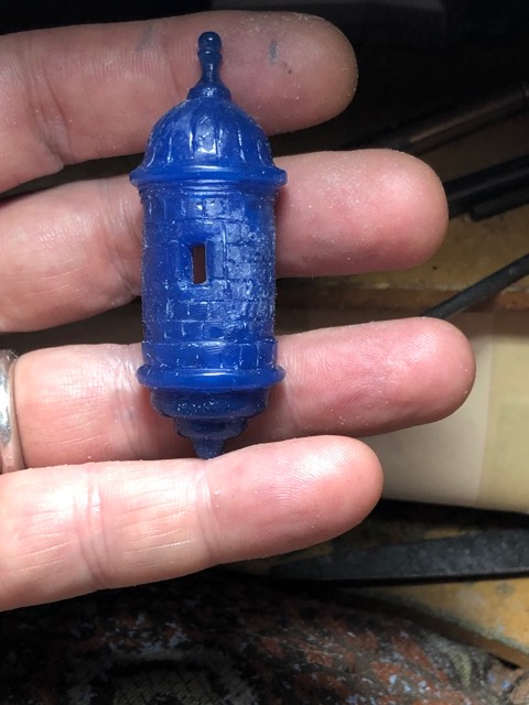 Hand-carved wax model of the Castillo San Felipe garita watchtower held at true scale before casting — AJ's Jewelry Queens NY