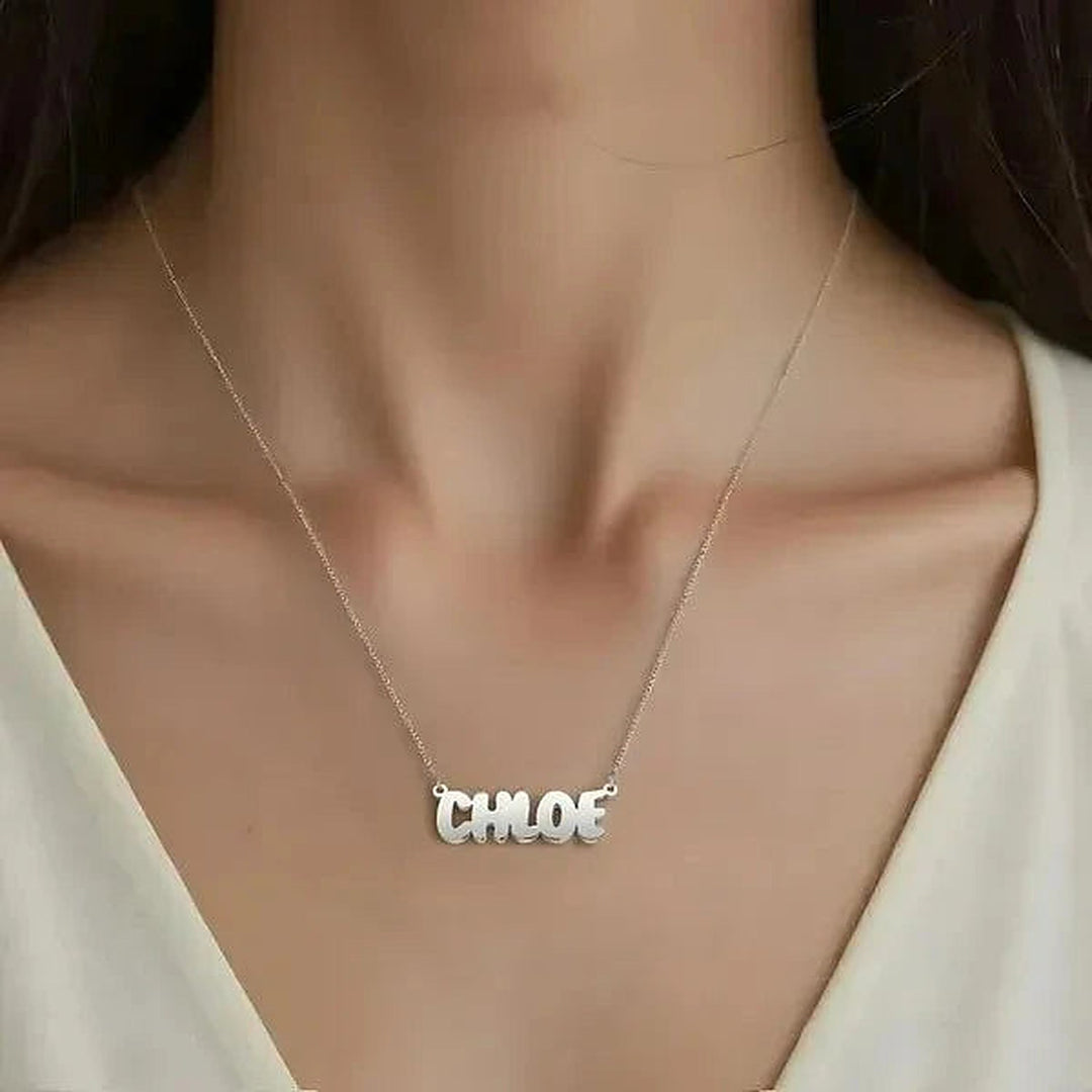 Model wearing the 14 Karat Bubble Letter Name Necklace in 14K white gold personalized with the name Chloe | AJ's Jewelry