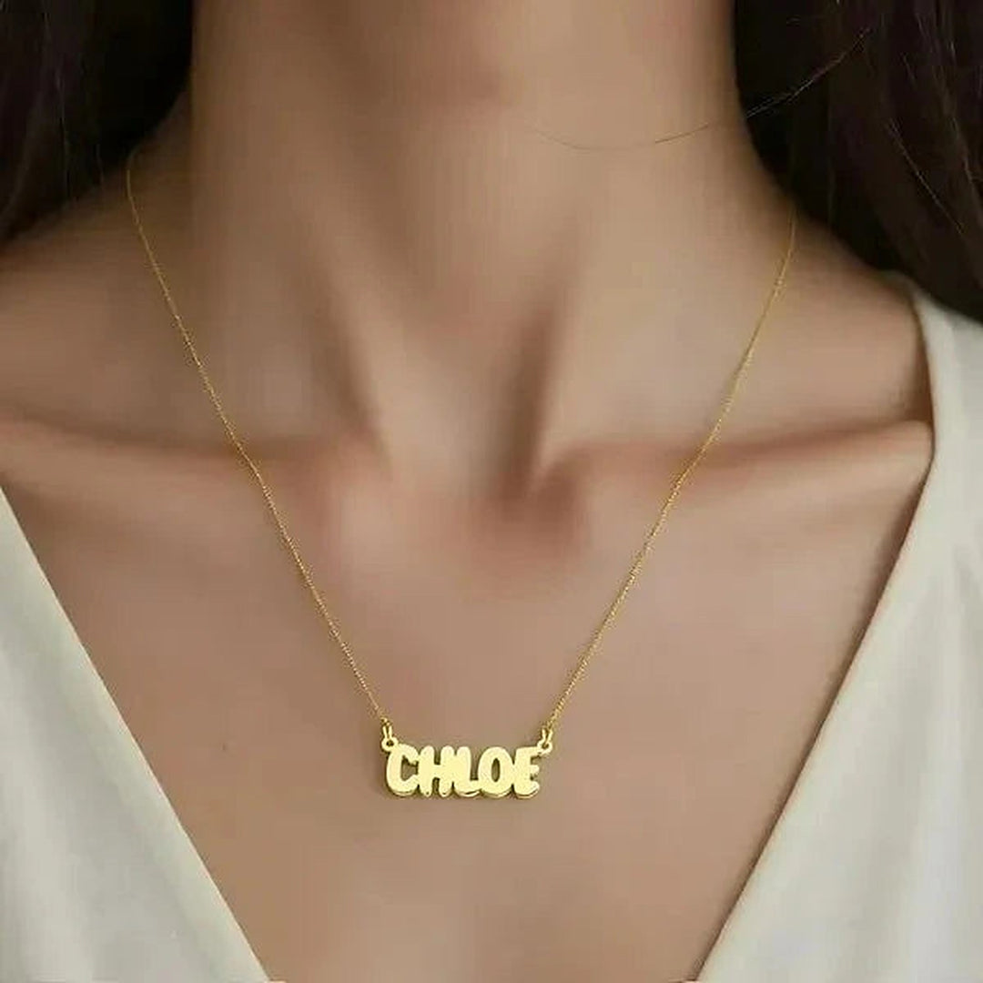 Model wearing the 14 Karat Bubble Letter Name Necklace in 14K yellow gold personalized with the name Chloe | AJ's Jewelry