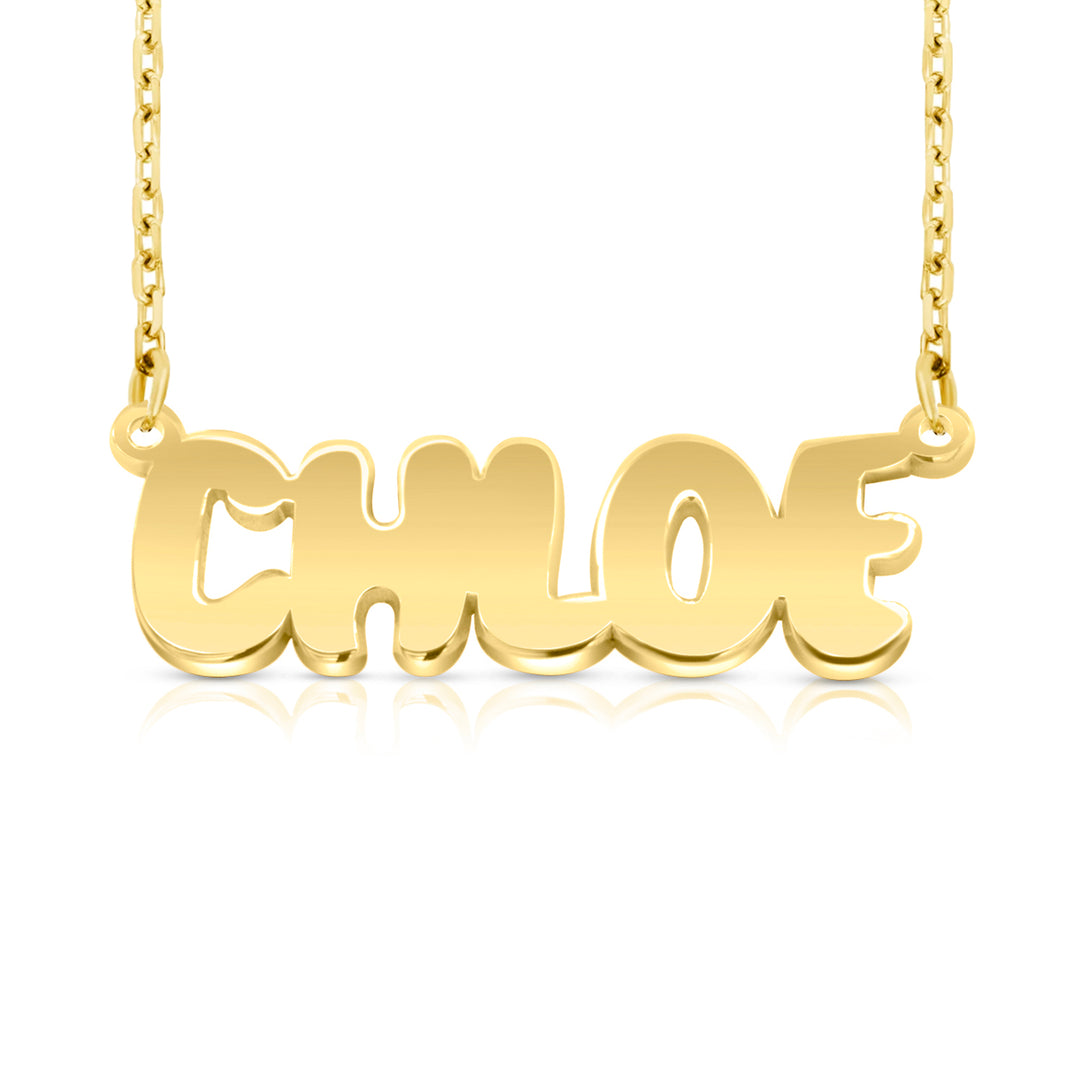 A gold nameplate necklace spelling 'CHLOE' in a bold, rounded font, suspended from a delicate gold chain against a clean white background with a soft reflection below.  This photo can change appearance depending on the name input using the custom name builder