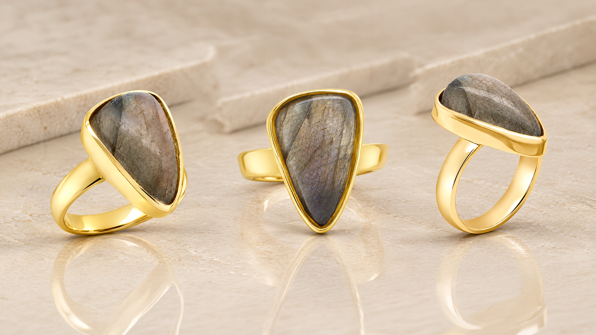 Three views of the custom 14 karat yellow gold pear shaped labradorite ring made at AJ's Jewelry in Queens NY