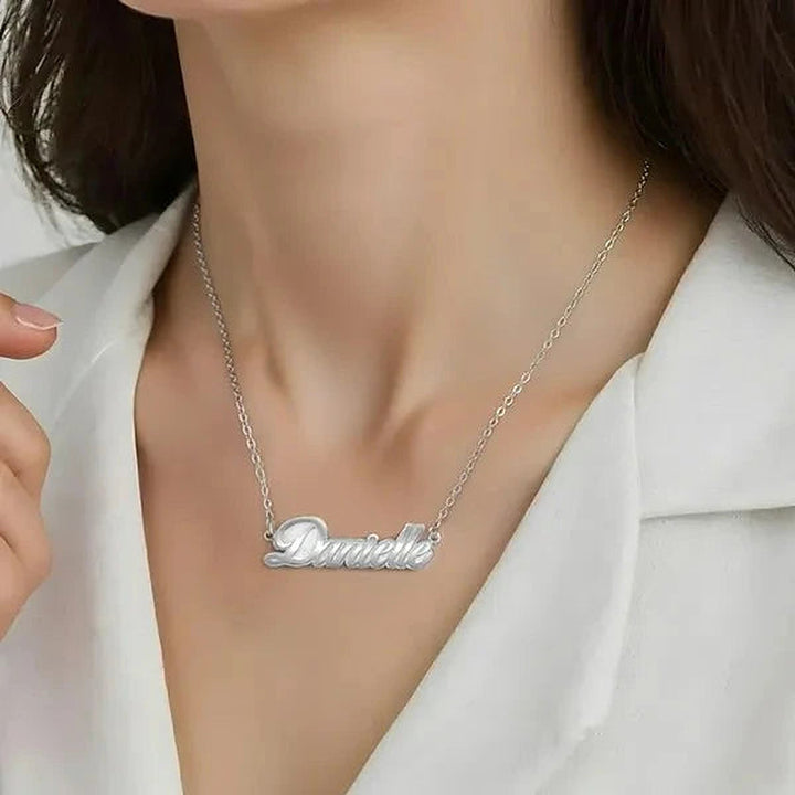 Model wearing the 14 Karat Fancy Script Name Necklace in 14K white gold personalized with the name Danielle | AJ's Jewelry