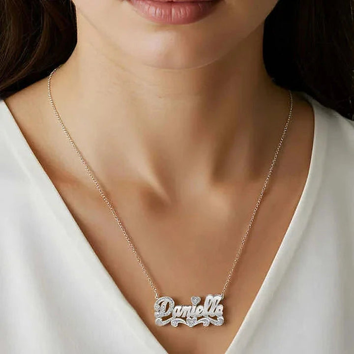 Model wearing the 14 Karat Polished and Diamond Cut 3D Name Necklace in 14K white gold, name Danielle | AJ's Jewelry