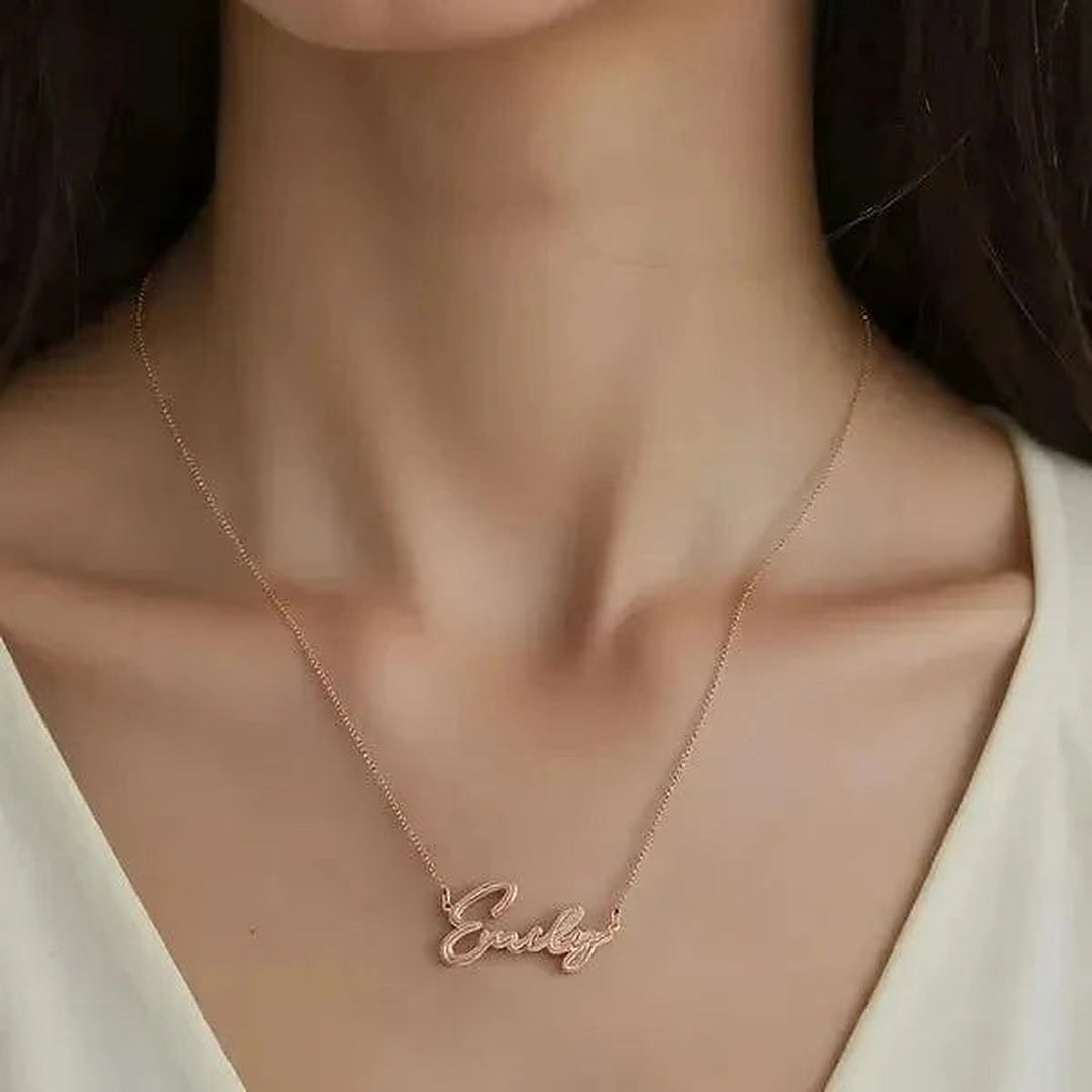 Model wearing the 14 Karat Thin Script Name Necklace in 14K rose gold personalized with the name Emily | AJ's Jewelry