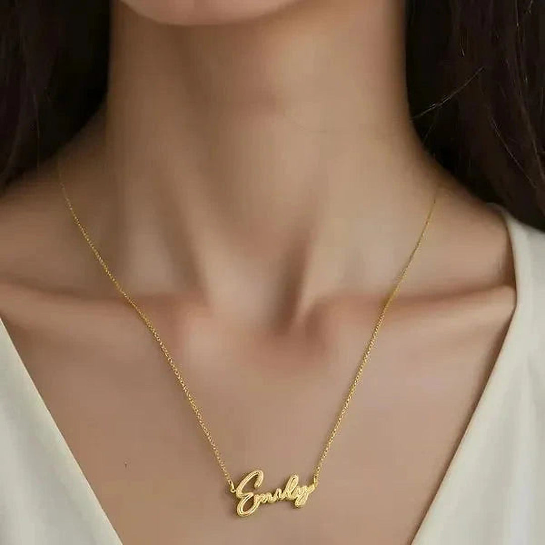 Model wearing the 14 Karat Thin Script Name Necklace in 14K yellow gold personalized with the name Emily | AJ's Jewelry
