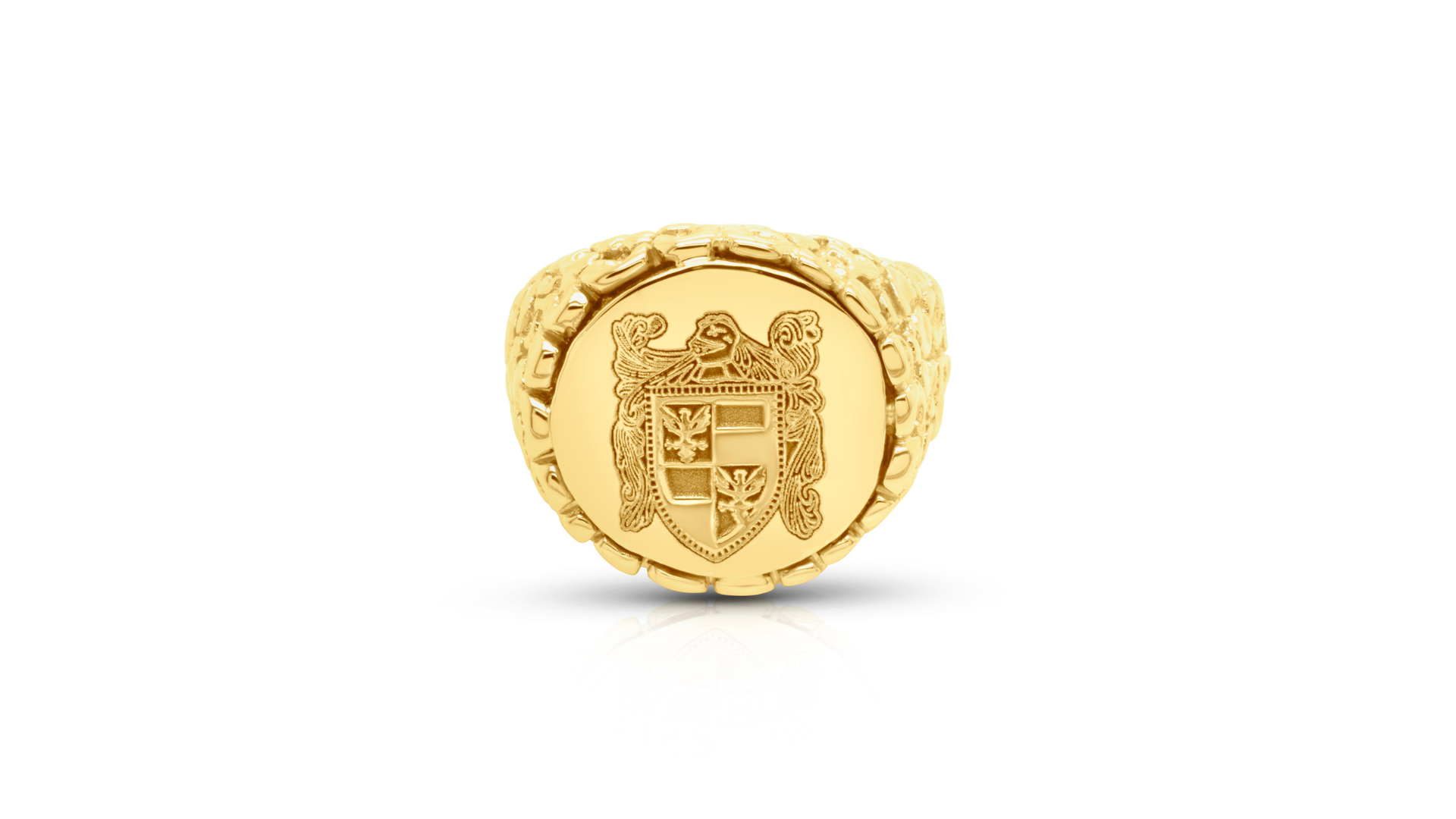 Gold signet ring with a detailed family crest emblem on a white background