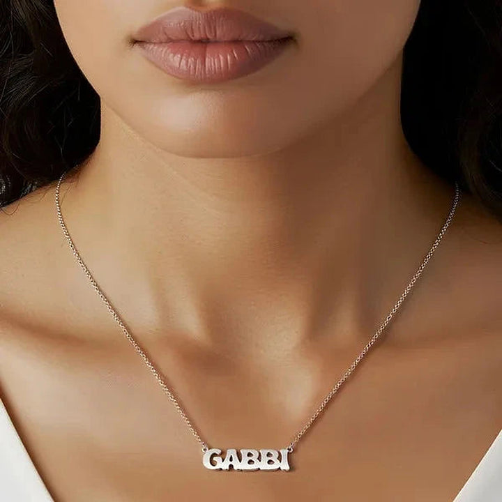 Model wearing the 14 Karat Retro Letter Style Name Necklace in 14K white gold personalized with the name Gabbi | AJ's Jewelry