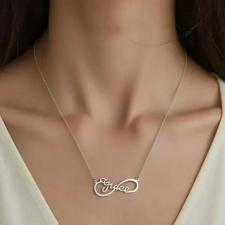 Model wearing the 14 Karat Infinity Style Name Necklace in 14K white gold personalized with the name Grace | AJ's Jewelry