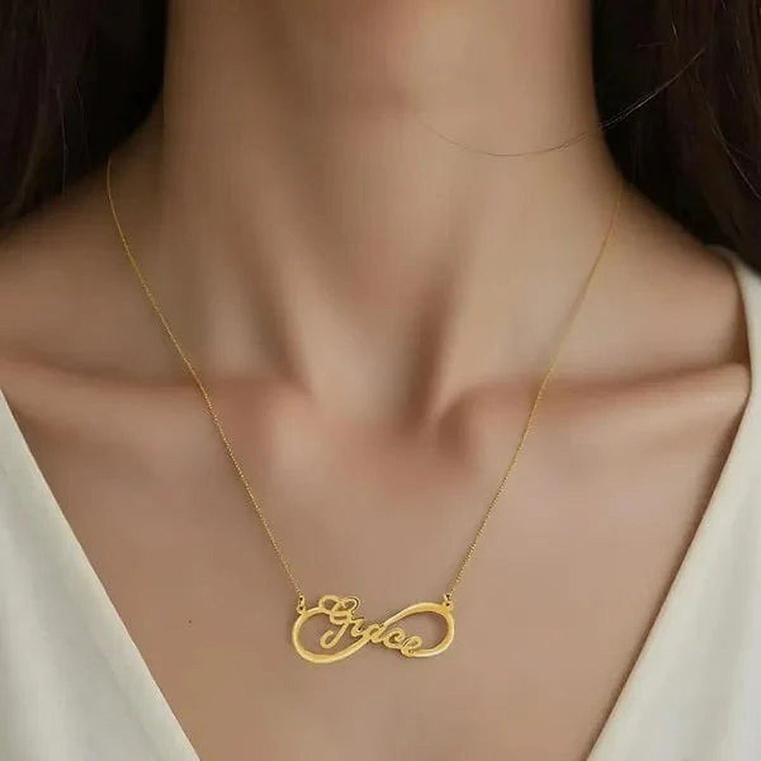 Model wearing the 14 Karat Infinity Style Name Necklace in 14K yellow gold personalized with the name Grace | AJ's Jewelry