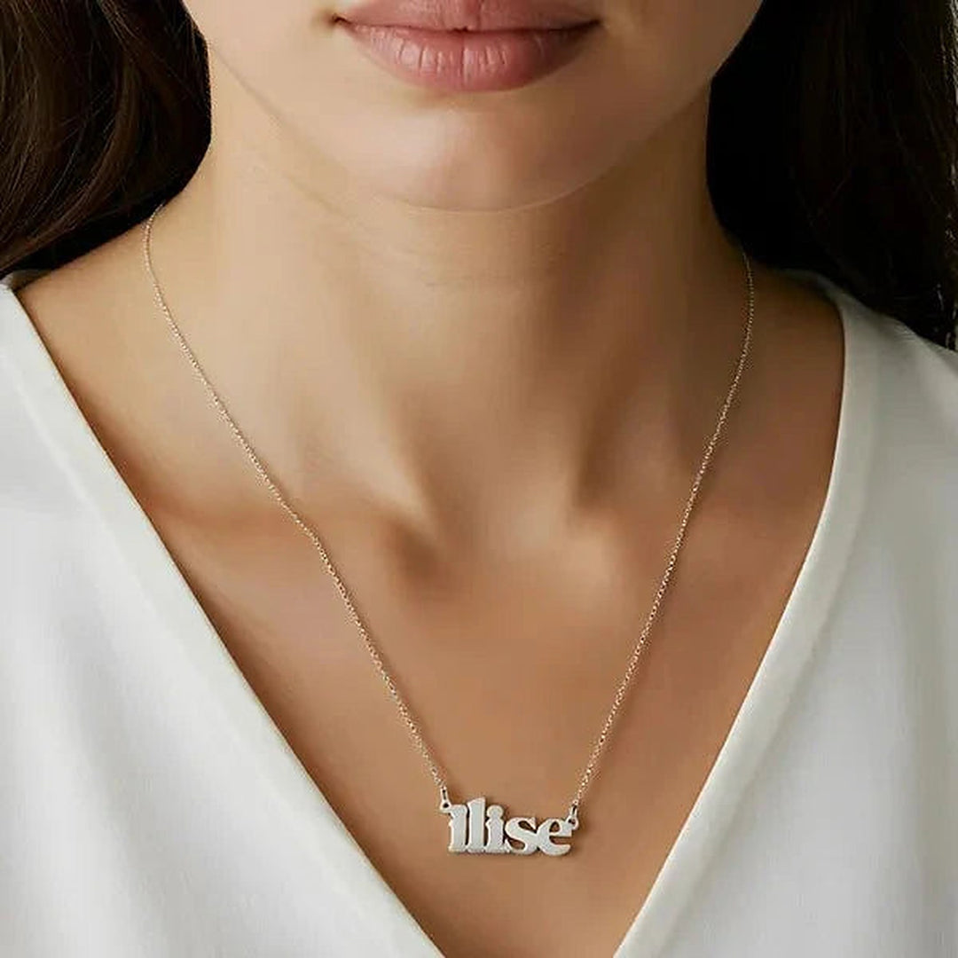 Model wearing the Sterling Silver Lowercase Bold Name Necklace personalized with the name Ilise | AJ's Jewelry