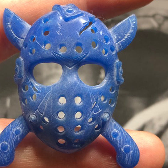 Hand-carved wax model of the Jason hockey mask held at true scale before casting in gold — AJ's Jewelry Queens NY