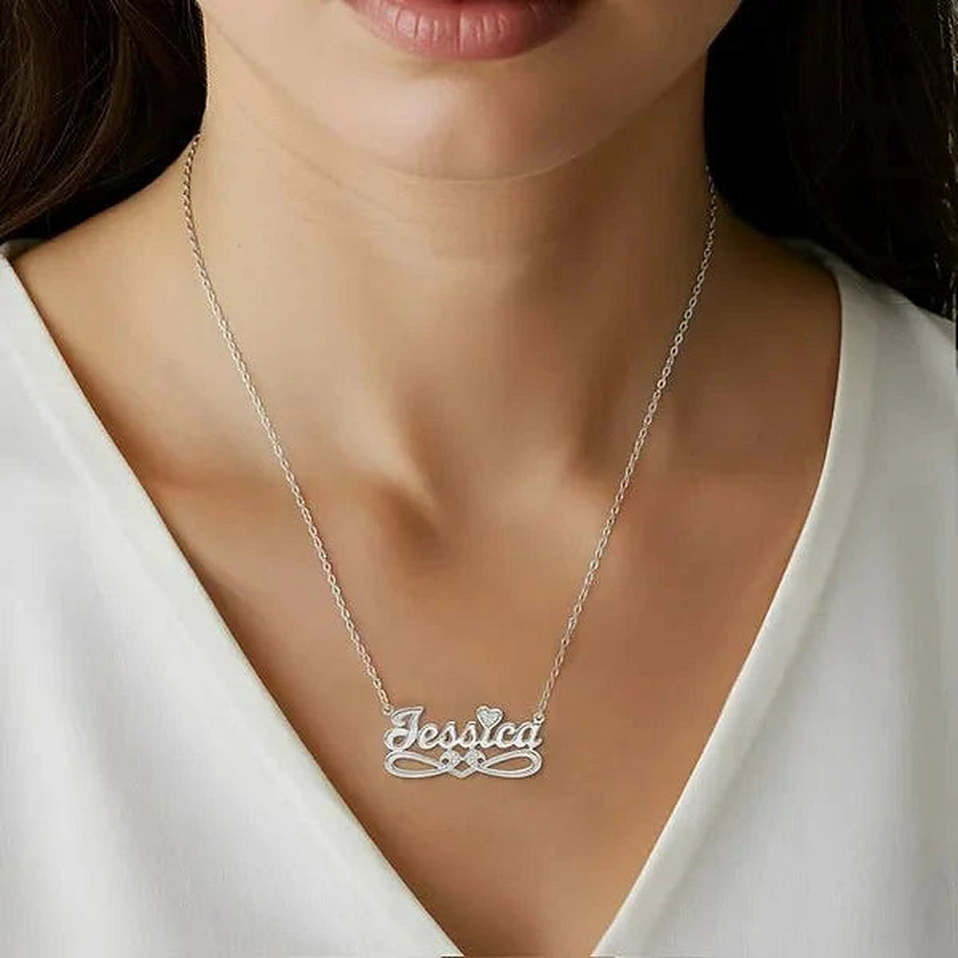 Model wearing the 14 Karat Bold Script Name Necklace with Tail in 14K white gold personalized with the name Jessica | AJ's Jewelry