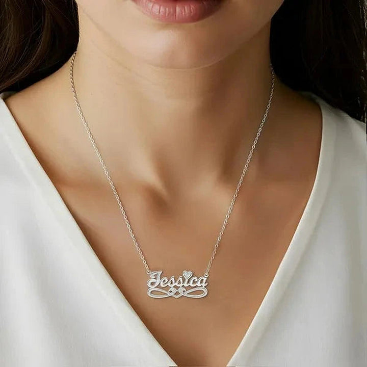 Model wearing the 14 Karat Bold Script Name Necklace with Tail in 14K white gold personalized with the name Jessica | AJ's Jewelry