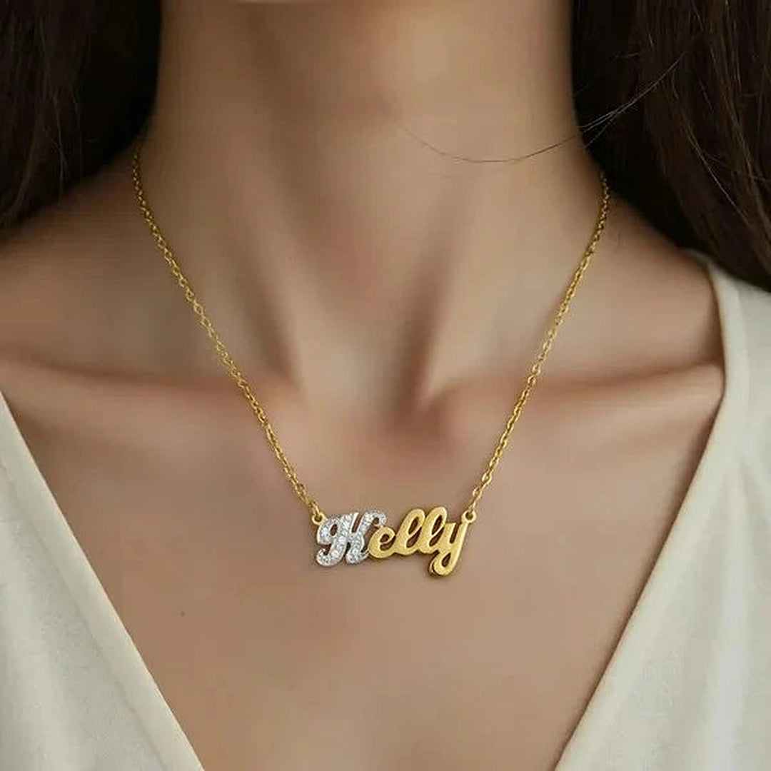 Model wearing the 14 Karat Small Name Necklace in 14K yellow gold personalized with the name Kelly | AJ's Jewelry