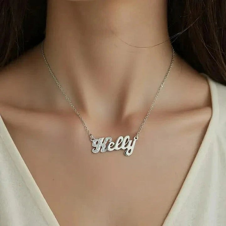 Model wearing the 14 Karat Small Name Necklace in 14K white gold personalized with the name Kelly | AJ's Jewelry