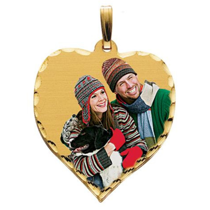 A heart-shaped gold pendant featuring a custom photo of a couple and a dog, with a diamond cut edge and a gold bail at the top, shown on a plain white background.
