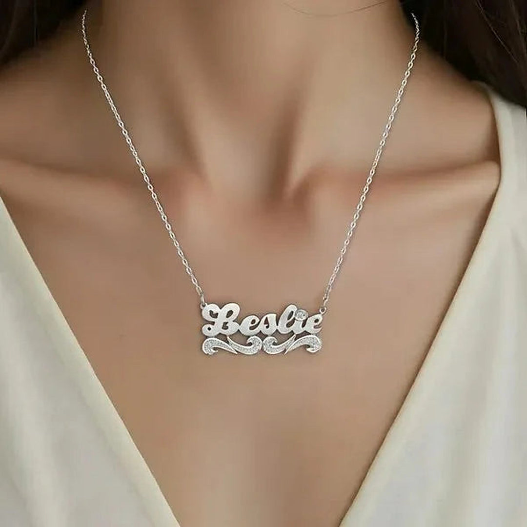 Model wearing the 14 Karat Script Name Necklace with Tail in 14K white gold personalized with the name Leslie | AJ's Jewelry