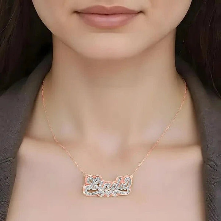 Model wearing the 14 Karat 3D Name Necklace with Solid Back Plate in 14K rose gold personalized with the name Linda | AJ's Jewelry