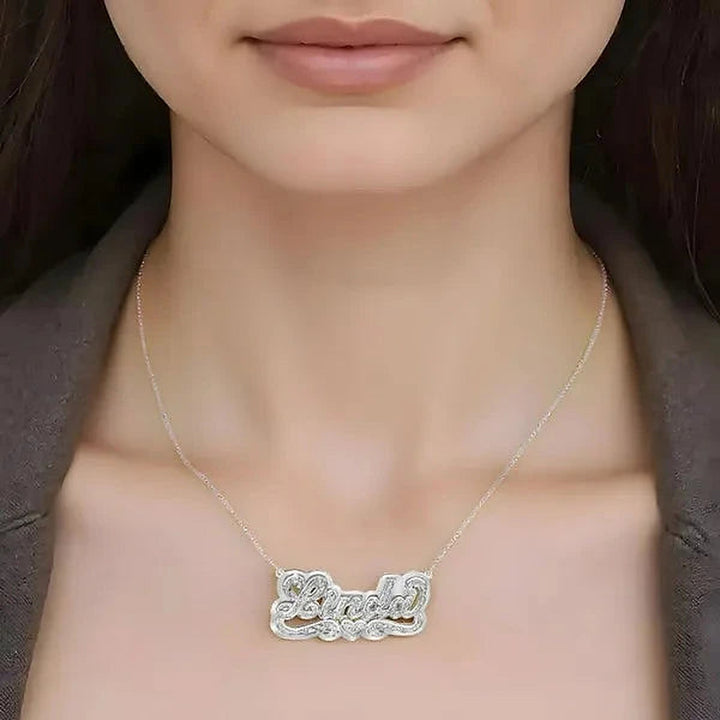 Model wearing the 14 Karat 3D Name Necklace with Solid Back Plate in 14K white gold personalized with the name Linda | AJ's Jewelry