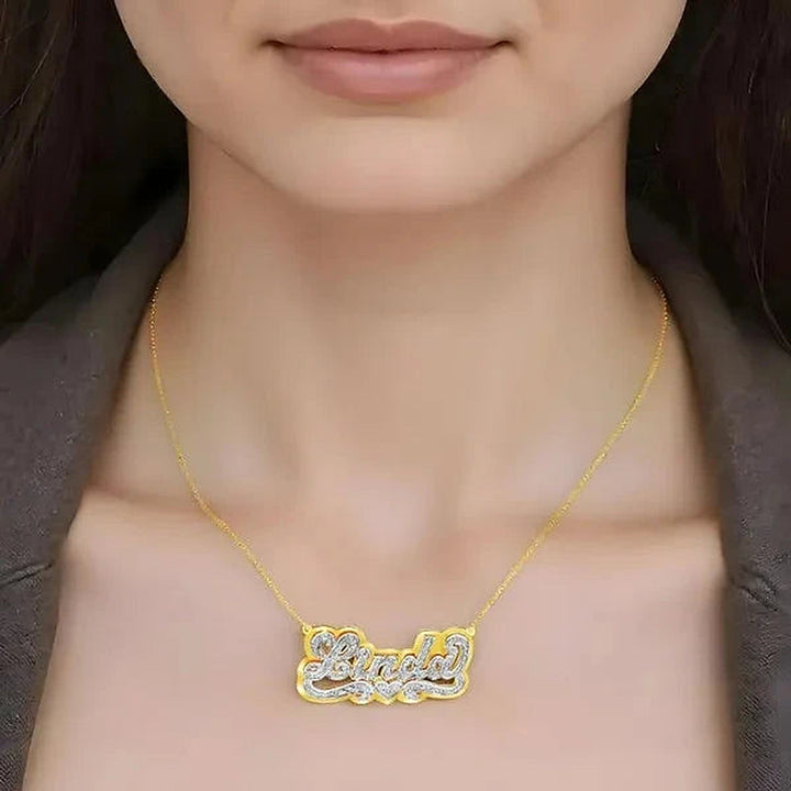 Model wearing the 14 Karat 3D Name Necklace with Solid Back Plate in 14K yellow gold personalized with the name Linda | AJ's Jewelry