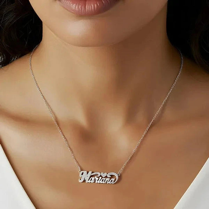 Model wearing the 14 Karat Small Name Necklace with Heart in 14K white gold personalized with the name Marina | AJ's Jewelry