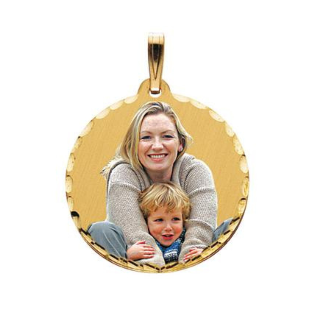 A round gold picture pendant with a smiling blonde woman holding a young child, shown on a plain white background.