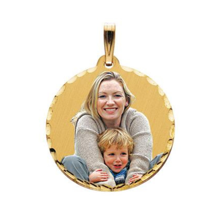 A round gold picture pendant with a smiling blonde woman holding a young child, shown on a plain white background.