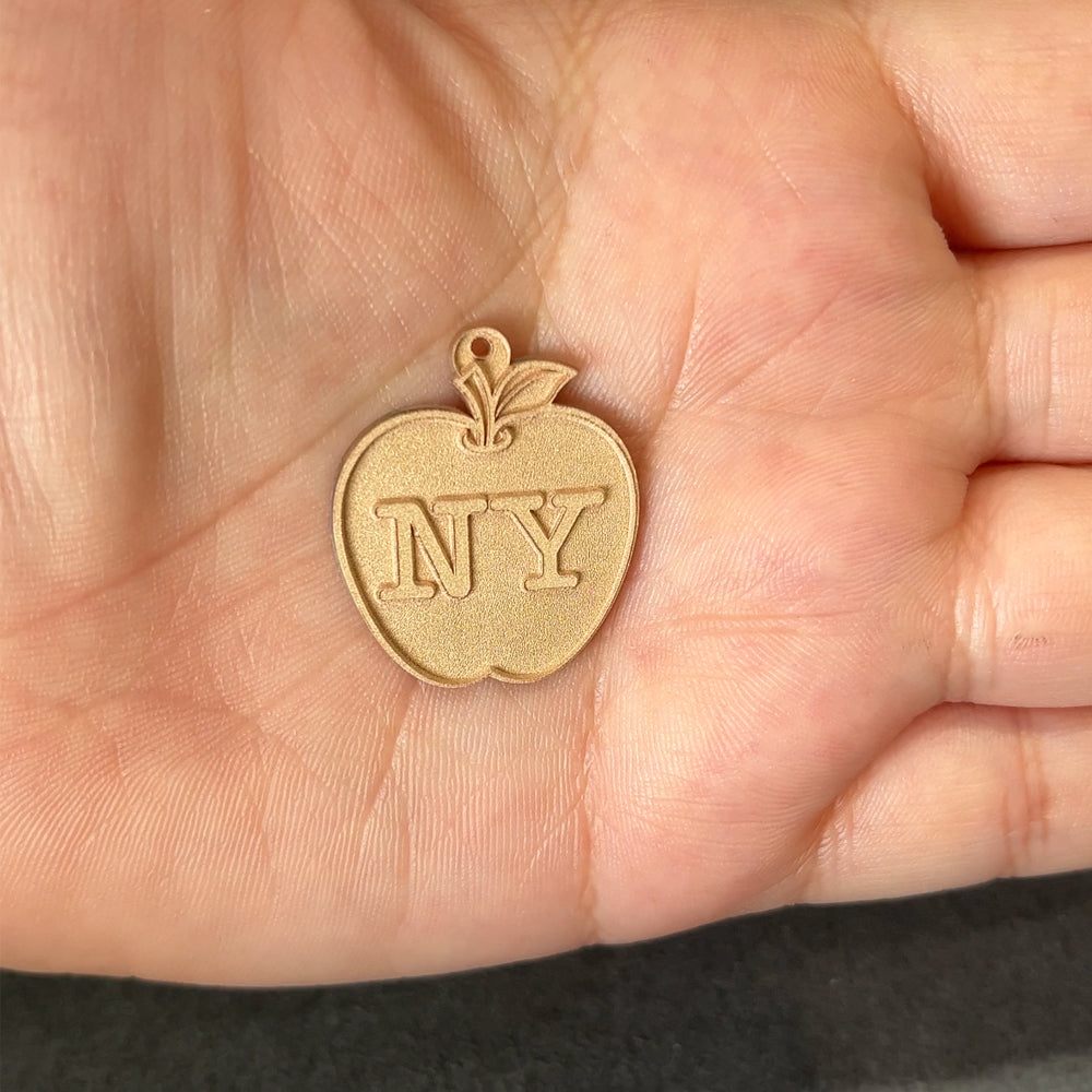 14kt yellow gold New York apple pendant after laser engraving and cutting, before hand finishing at AJ's Jewelry Queens NY