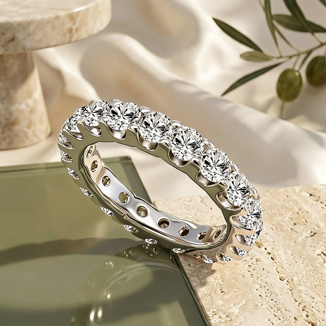 Platinum 3ct lab grown diamond eternity band shown at an angle on a styled display at AJ's Jewelry in Ridgewood, Queens NY