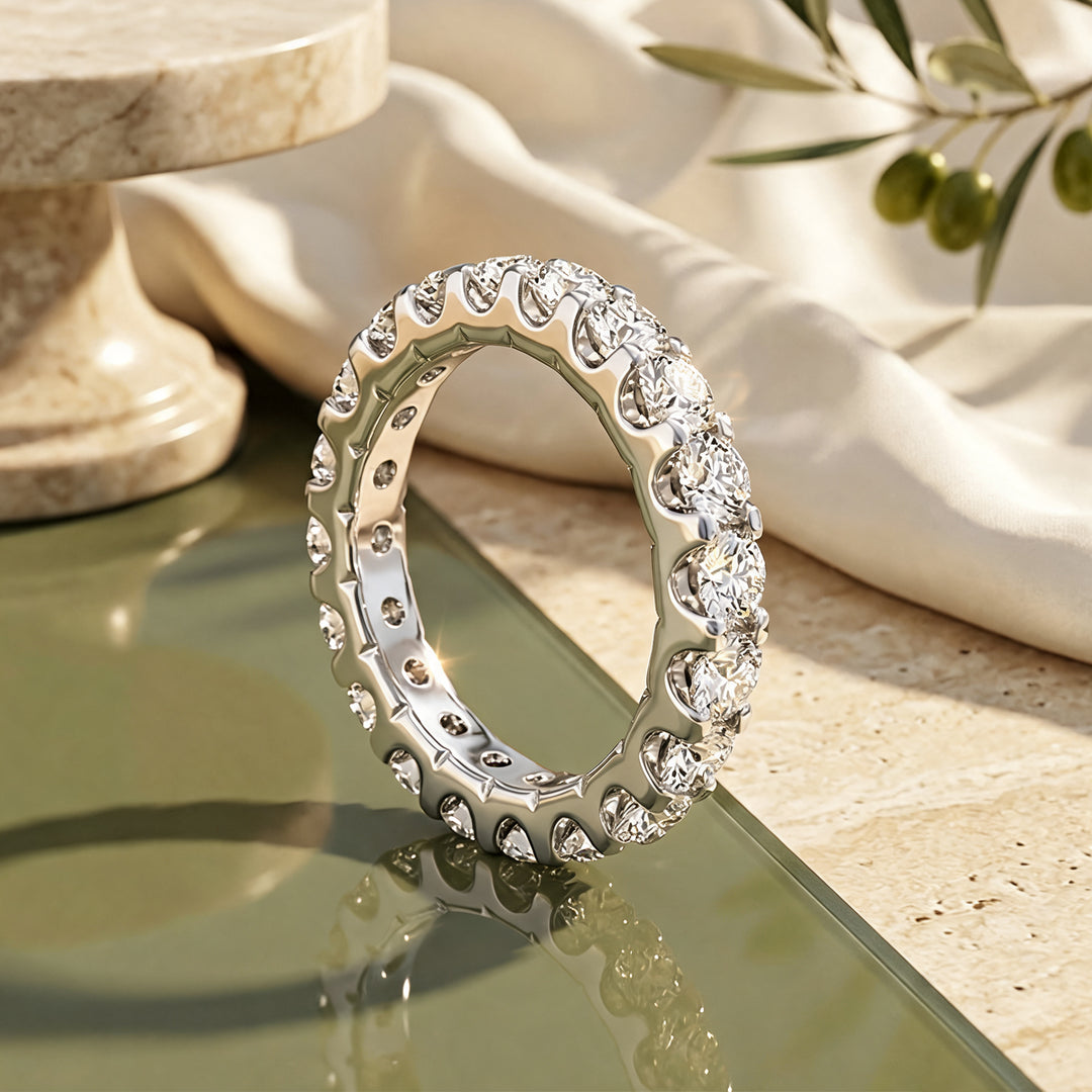 Platinum 3ct lab grown diamond eternity band shown from the side on a styled display at AJ's Jewelry in Ridgewood, Queens NY