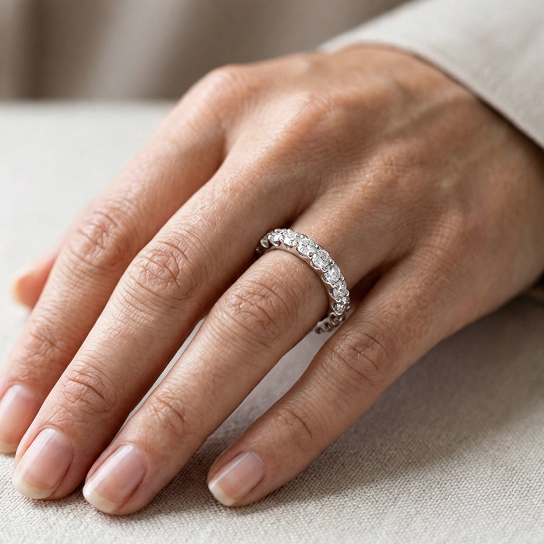 Platinum 3ct lab grown diamond eternity band worn on a hand at AJ's Jewelry in Ridgewood, Queens NY