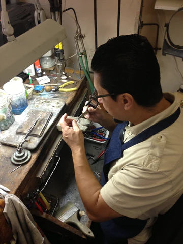 Goldsmith working with a piece of jewelry