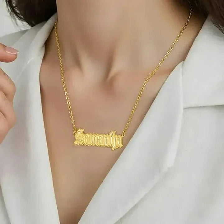 Model wearing the 14 Karat Gothic Style Name Necklace in 14K yellow gold personalized with the name Samantha | AJ's Jewelry