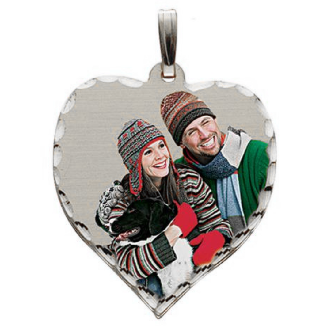 A heart-shaped silver pendant featuring a custom photo of a couple and a dog, with a diamond cut edge and a silver bail at the top, shown on a plain white background.