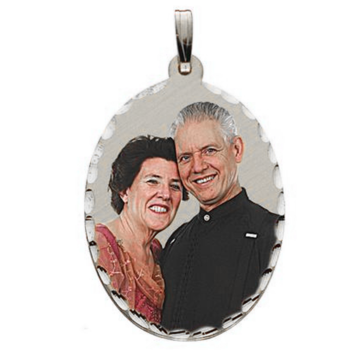 An oval silver pendant charm featuring a picture of a smiling couple, complete with a silver bail at the top, shown on a plain white background.