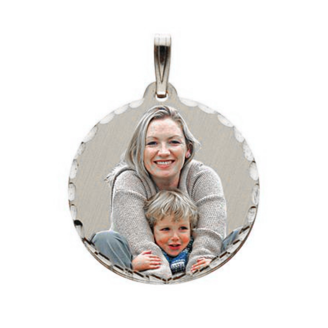 A round silver picture pendant with a smiling blonde woman holding a young child, shown on a plain white background.