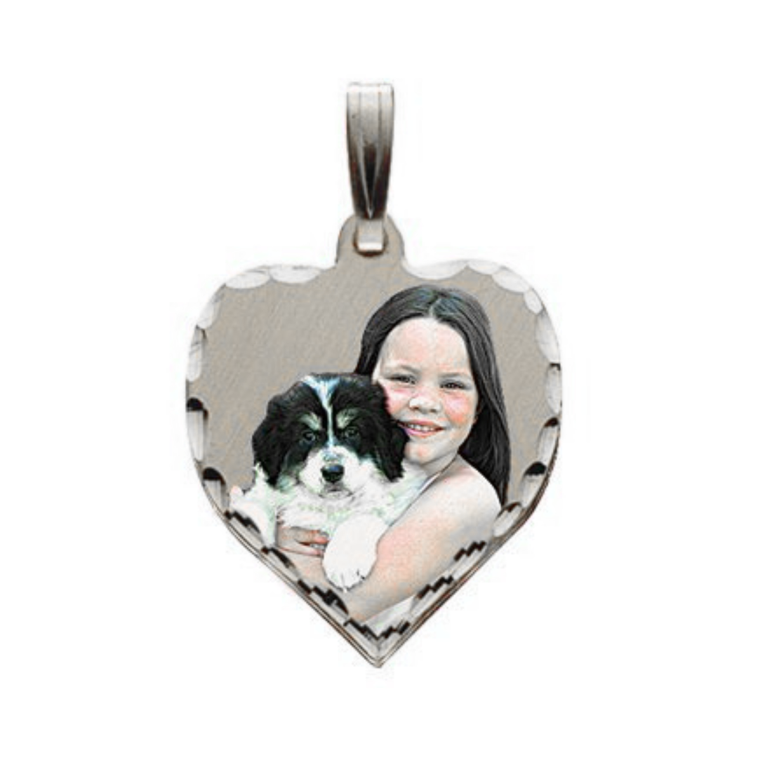 A heart-shaped silver picture pendant featuring a custom photo of a girl hugging a black and white puppy, shown on a plain white background.