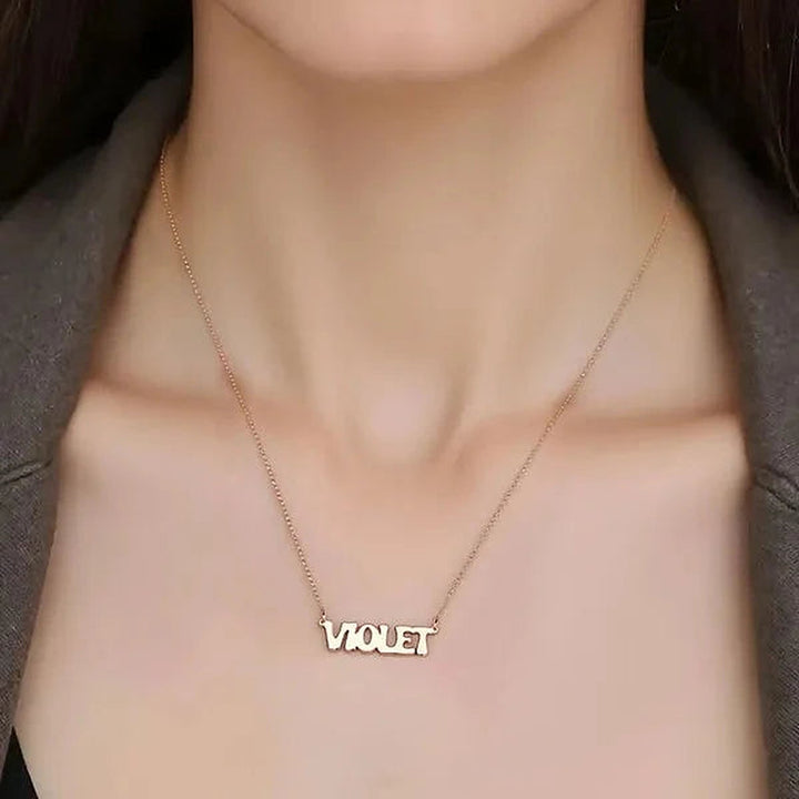 Model wearing the 14 Karat Retro Letter Style Name Necklace in 14K rose gold personalized with the name Violet | AJ's Jewelry