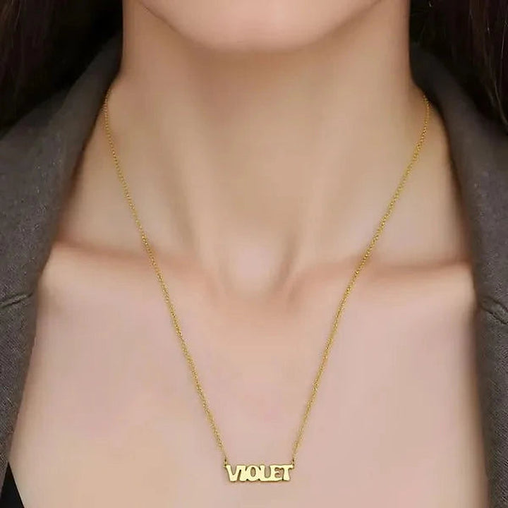 Model wearing the 14 Karat Retro Letter Style Name Necklace in 14K yellow gold personalized with the name Violet | AJ's Jewelry