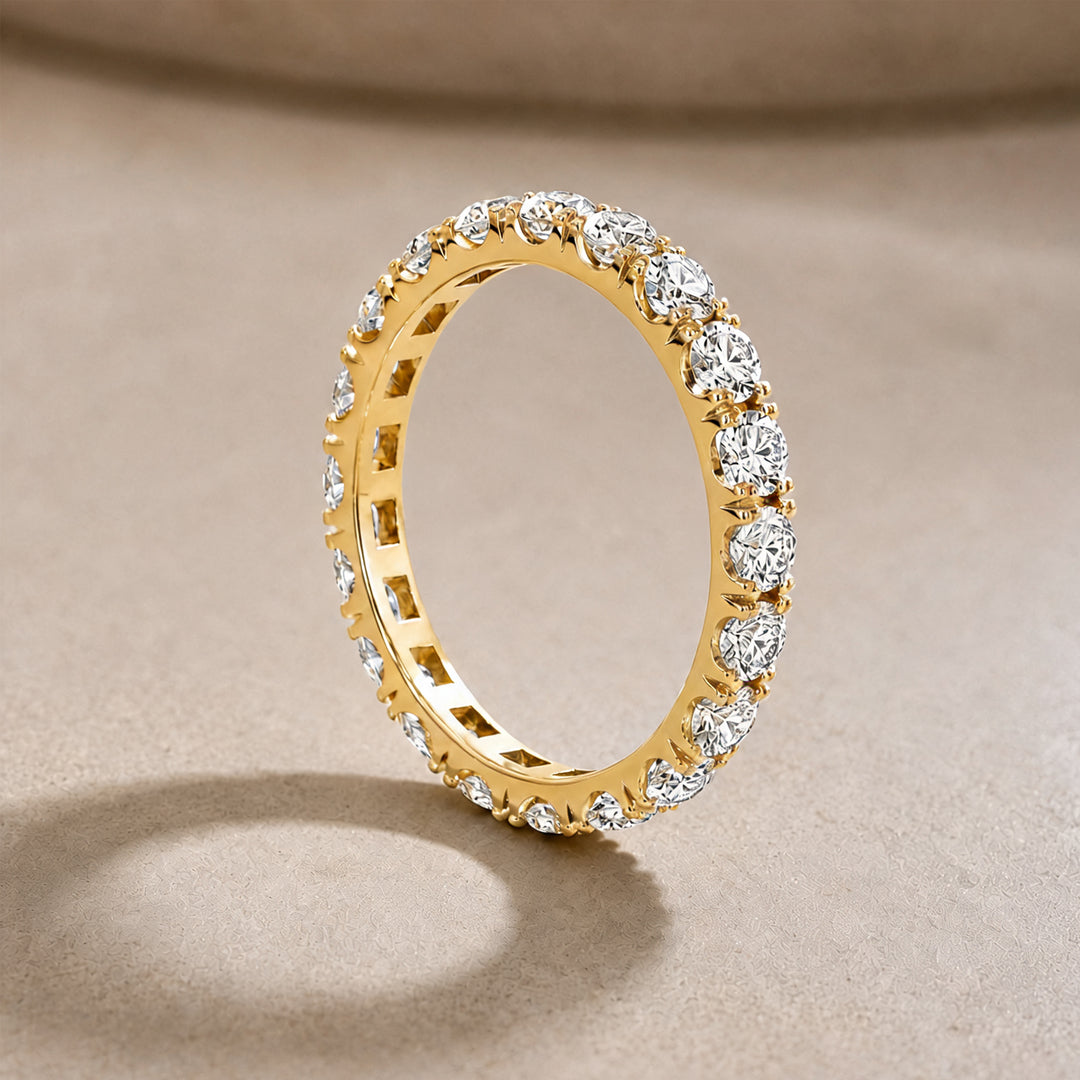 14k yellow gold lab grown diamond eternity band, side angle on a styled display - AJ's Jewelry Queens NY
